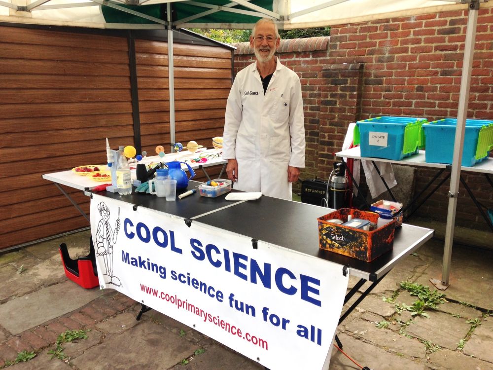 A photo Cool Pete at his science stall with equipment on the table